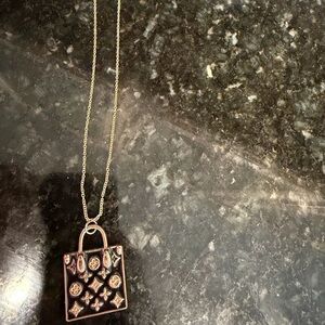 Large black pendant on costume jewelry chain